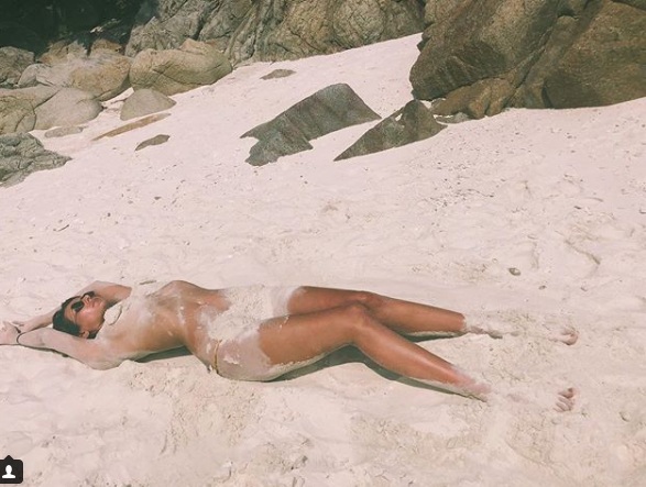 Mandana Karimi poses topless on beach