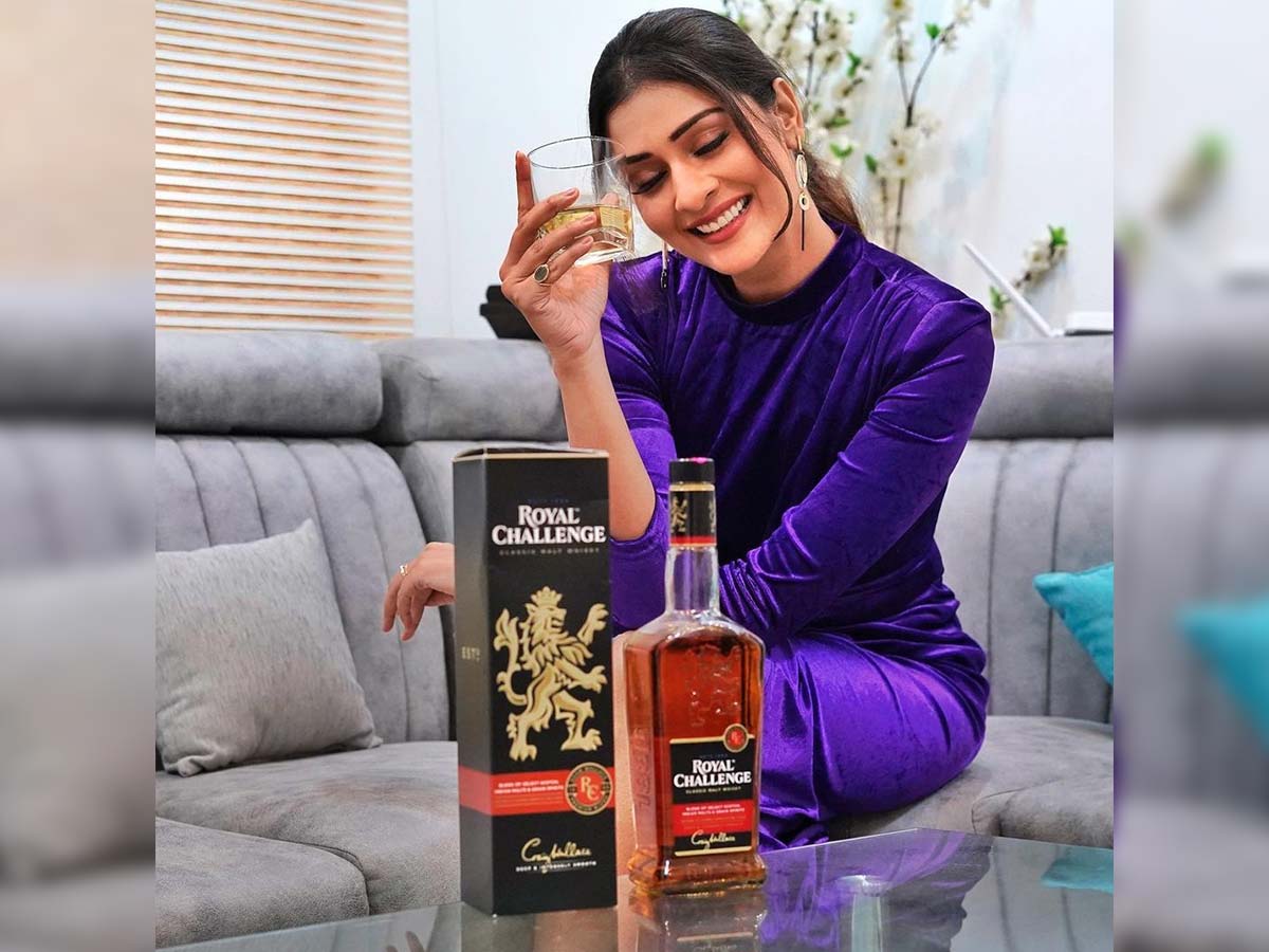 Payal Rajput with whisky bottle