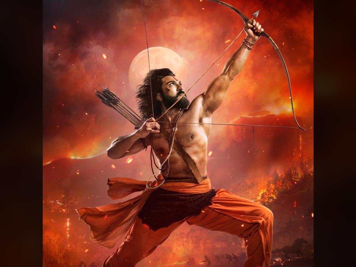 RRR Ram Charan as Alluri Sitarama Raju holds bow and arrow