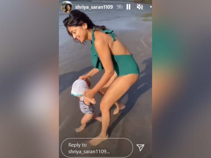 Bikini lady Shriya Saran holds daughter Radha hands on beach